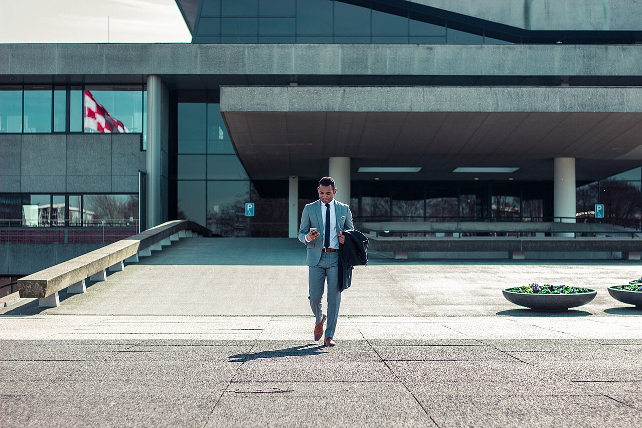 Professional in a suit leaving an office, criminal charge and professional licence consequences Ontario