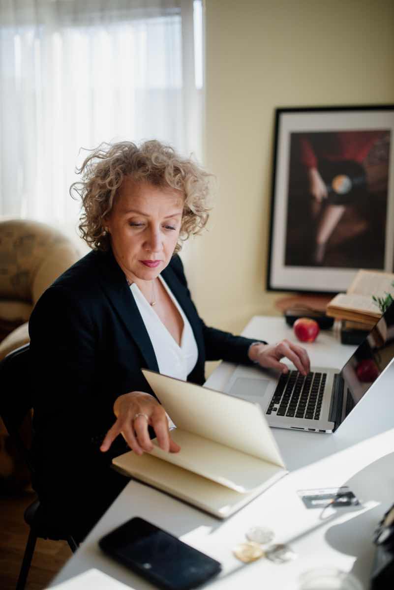 Regulated professional working at an office desk, criminal charges and professional licence consequences in Ontario
